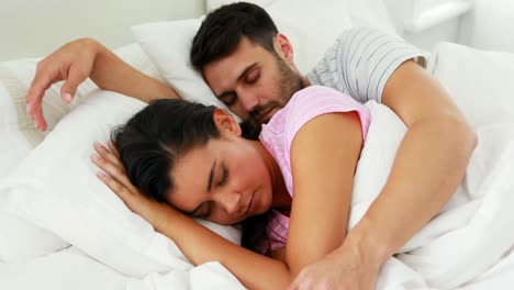 Couple-sleeping-on-bed-in-bedroom