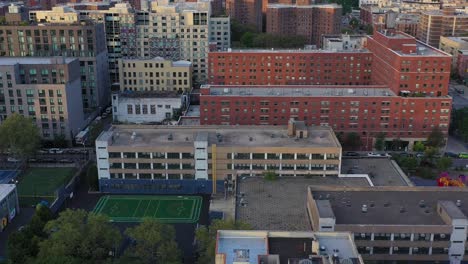 aerial footage turns across the harlem neighborhood of nyc at golden hour sunrise