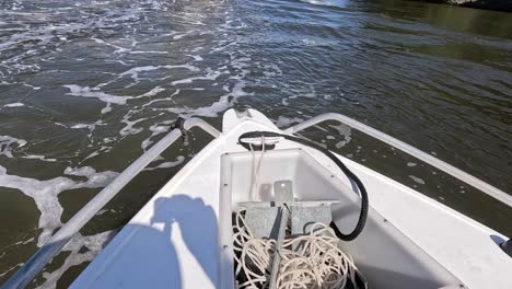 a boat moves steadily through calm waters