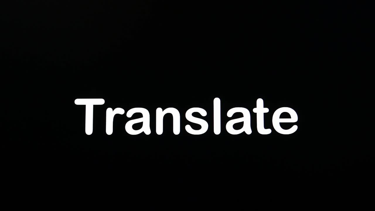 Typing on the screen with a flashing paragraph forming the word Translate, in white on a black background