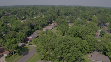 aerial-flyover-suburban-landscape-with-houses-trees-and-streets