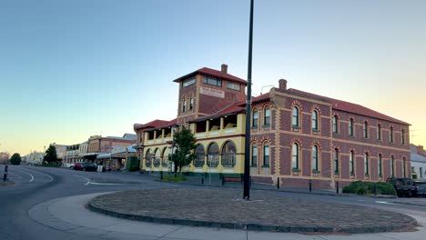 a serene sunset view of the historic vue grand hotel in queenscliff, victoria, with warm lighting and calm ambiance