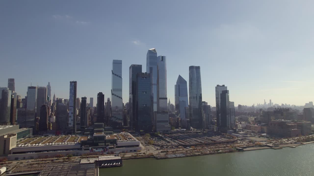 Expansive drone view of Hudson Yards, the Javits Center, and Manhattan skyline during clear daylight, seen from across the Hudson River