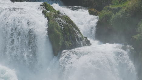 a waterfall with a large amount of water on a clean and wild mountain river