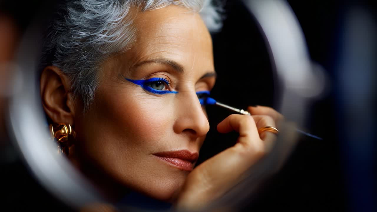 An Elegant Portrait of an Artistic Makeup Application Featuring Bold Blue Eyeliner and Captivating Beauty Reflected in a Mirror, Showcasing Modern Glamour and Sophistication