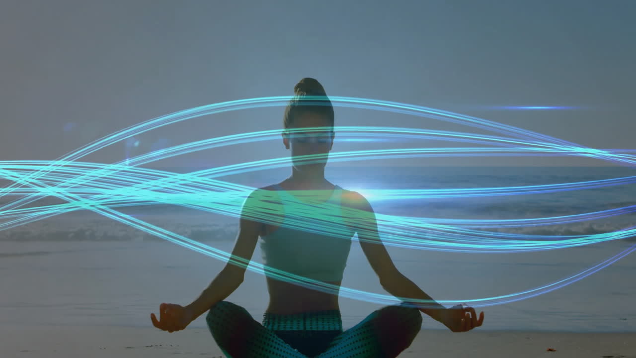 Meditating on beach, person surrounded by swirling blue light trails animation