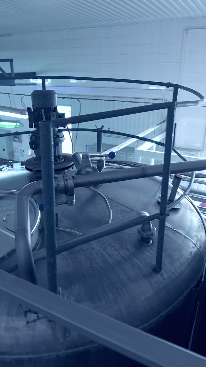 Milk production plant. Milk production technology in a large specialized farm. Agriculture production factory. Modern equipment on dairy plant.. Vertical video