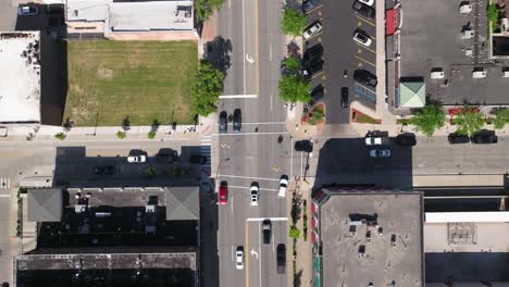 Downtown-Dearborn,-Michigan-intersection-with-traffic-and-drone-video-looking-down-from-overhead-moving-down