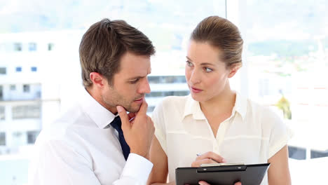 businesswoman going over checklist with colleague