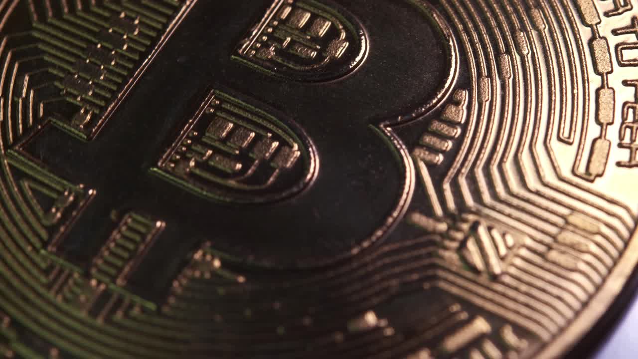 moneda criptográfica de 4k en moneda bitcoin girando lentamente en el sentido de las agujas del reloj con luz reflectante sobre fondo negro