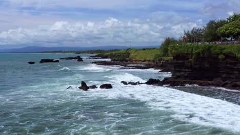 Idyllic-Seascape-Surrounding-Tanah-Lot-Temple-In-Bali,-Indonesia---aerial-shot