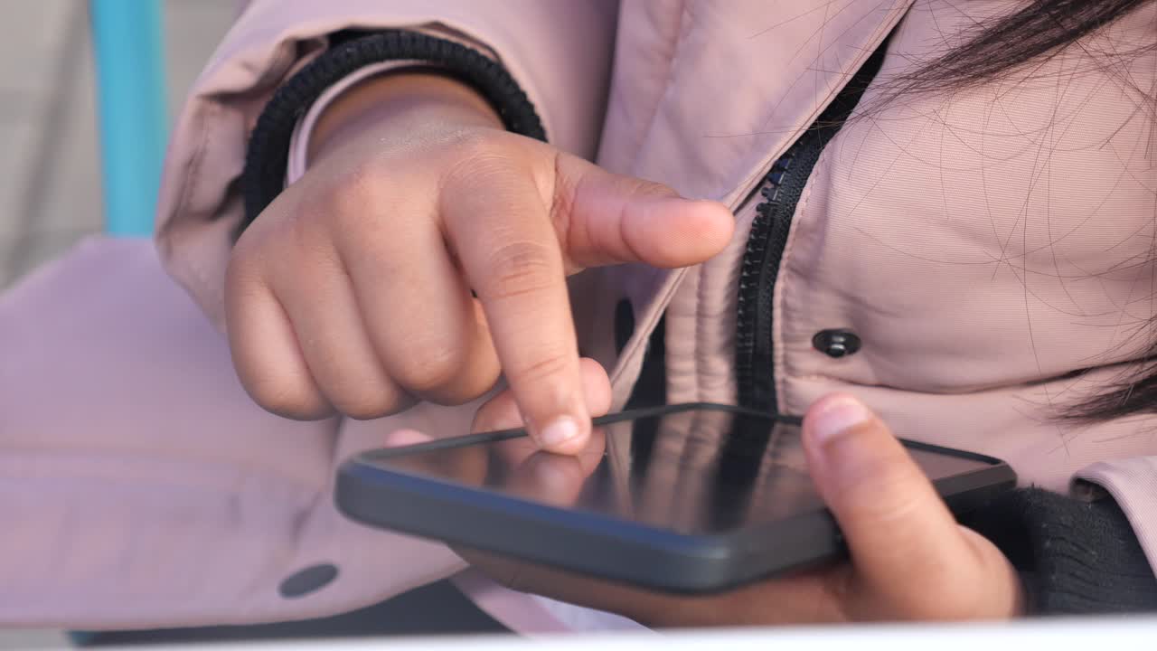 Close-up of a person's hands interacting with a smartphone