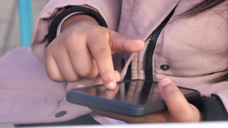 close-up of a person's hands interacting with a smartphone
