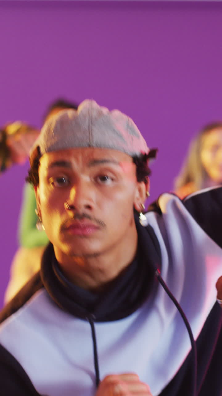 Vertical video of portrait of diverse male and female dancers dancing in dance studio