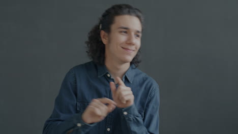 teenage boy smiling and pointing