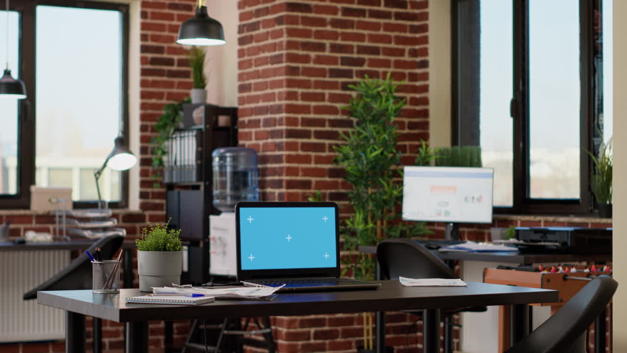 Empty business office with greenscreen on laptop computer