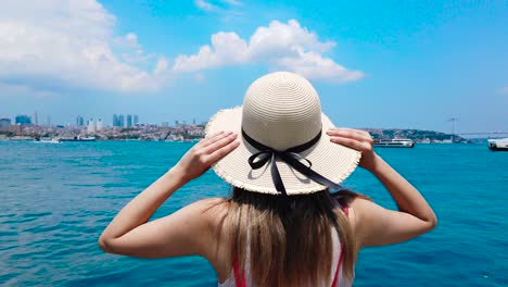 Slow-Motion:beautiful-girl-stands-in-front-of-Bosphorus,a-popular-destination-in-Istanbul,Turkey