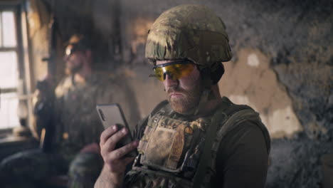 soldier using a smartphone in a military base