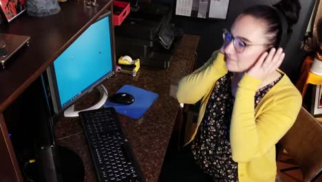 Woman-Listens-to-Music-at-Work-Desk-Before-Getting-Back-to-Work