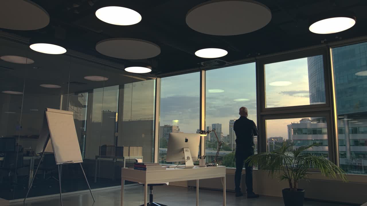 Businessman at Sunset Window View in Modern Office