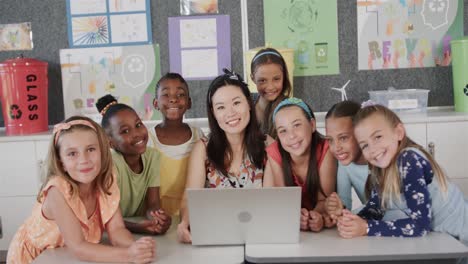 portrait of diverse female teacher and girls smiling in elementary school class, slow motion