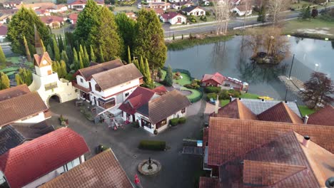 Aerial-view-of-a-Swiss-Style-village-near-a-manmade-lake-in-Australia