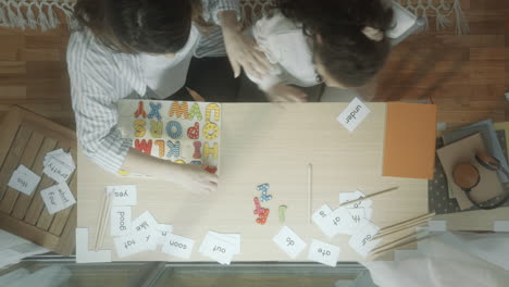 time lapse of little girl learning letters and words with mother