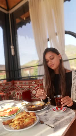 woman enjoying a meal at an outdoor cafe