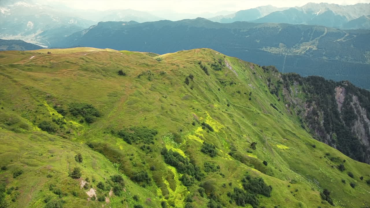 Aerial drone view of nature in Georgia. Caucasus Mountains, greenery, valleys, lush clouds