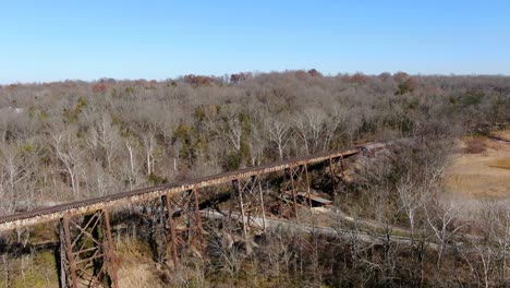 aerial shot orbiting the pope lick railroad trestle in louisville kentucky on a bright, sunny afternoon