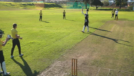 playing cricket on field, diverse team celebrating successful match moment