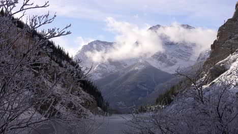 timelapse of clouds rolling by in the canadian rockies with a lake in the foreground.