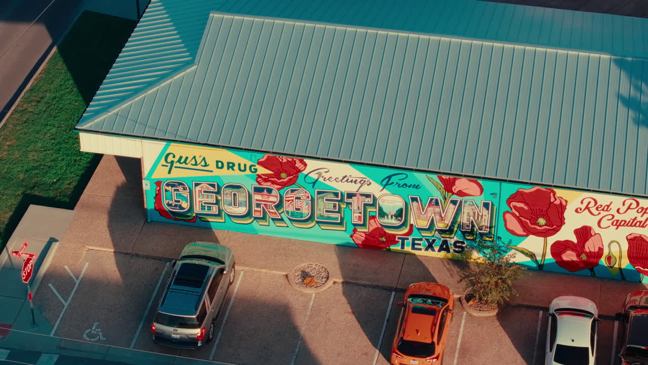 Close up drone orbit around "Greetings From Georgetown" mural in Austin Texas suburb Georgetown