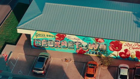 Close up drone orbit around &quot;Greetings From Georgetown&quot; mural in Austin Texas suburb Georgetown