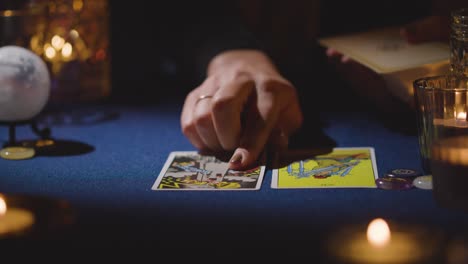 Close-Up-Of-Woman-Giving-Tarot-Card-Reading-On-Candlelit-Table-14