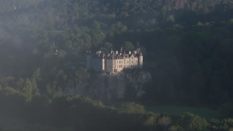 walzin castle reveal in the clouds on natural cliff, aerial