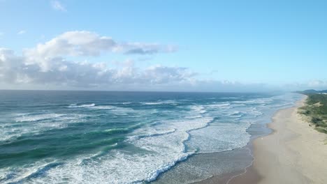 vertical panning shot of a beach at sunrise with nice blue water