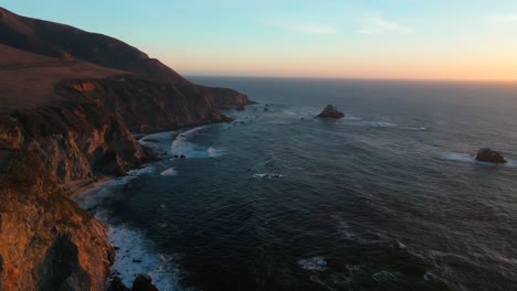 rugged california coastline big creek bixby creek bridge big sur sunset sunrise aerial drone waves santa lucia mountains apple screensaver pacific ocean coast highways one scenic route forward motion