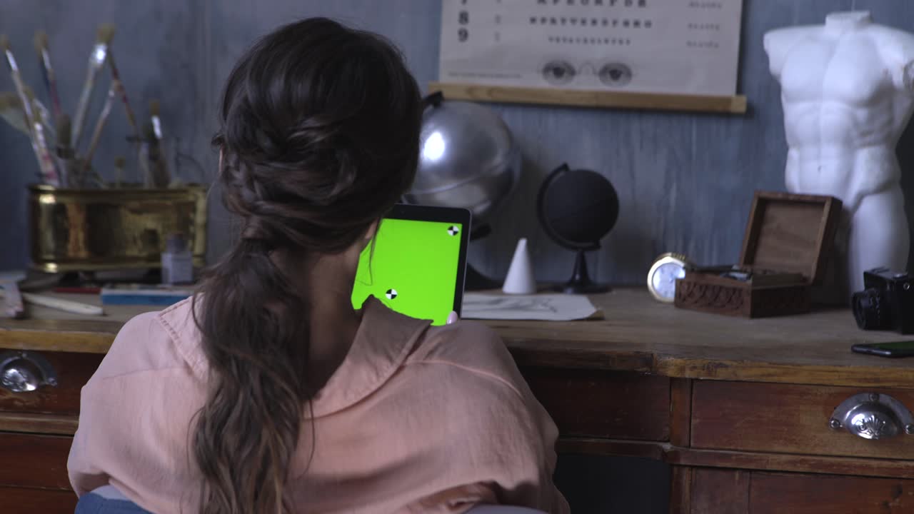 Woman using tablet at a vintage style desk