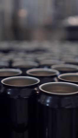 rows of empty aluminum cans on a production line