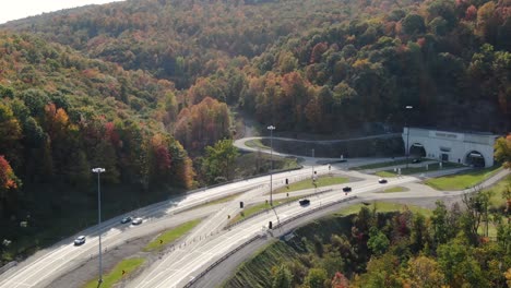 Allegheny-Mountain-highway-tunnel-on-PA-Turnpike-driving-to-Pittsburgh-Pennsylvania-during-autumn,-peak-fall-foliage-in-forest