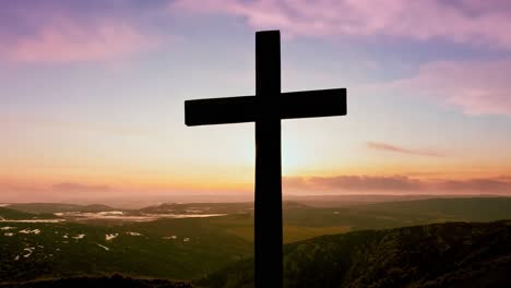 cross stands on a hill, beautifully illuminated by a vibrant sunset in the background, creating a serene atmosphere