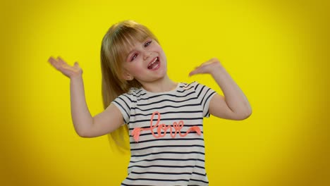 funny child kid girl making playful silly facial expressions and grimacing, fooling, showing tongue