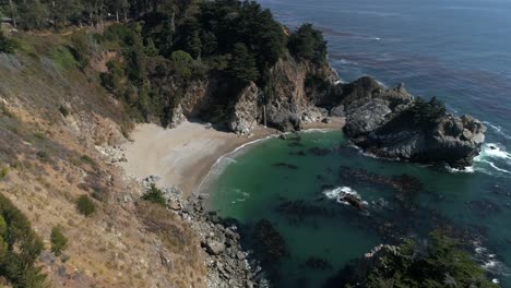 Aerial-shot-flying-over-trees-to-reveal-Water-Fall-McWay-Falls-Julia-Pfeiffer-Burns-Park-Big-Sur-California