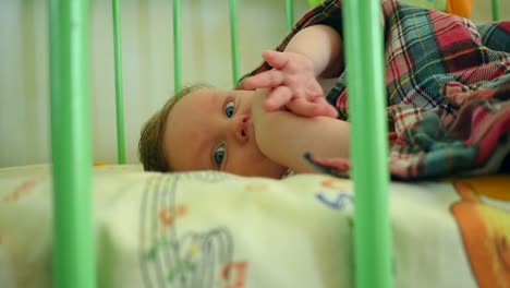 adorable baby boy lying in crib
