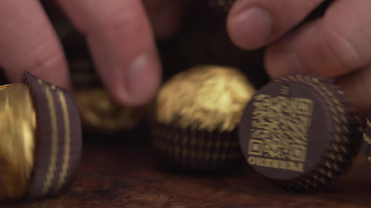 Delicious Ferrero Rocher chocolate candy balls, fancy golden packaging, famous popular sweet dessert treat, nice holiday gift, 4K shot