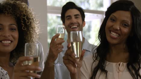 portrait of happy friends showing wine glasses
