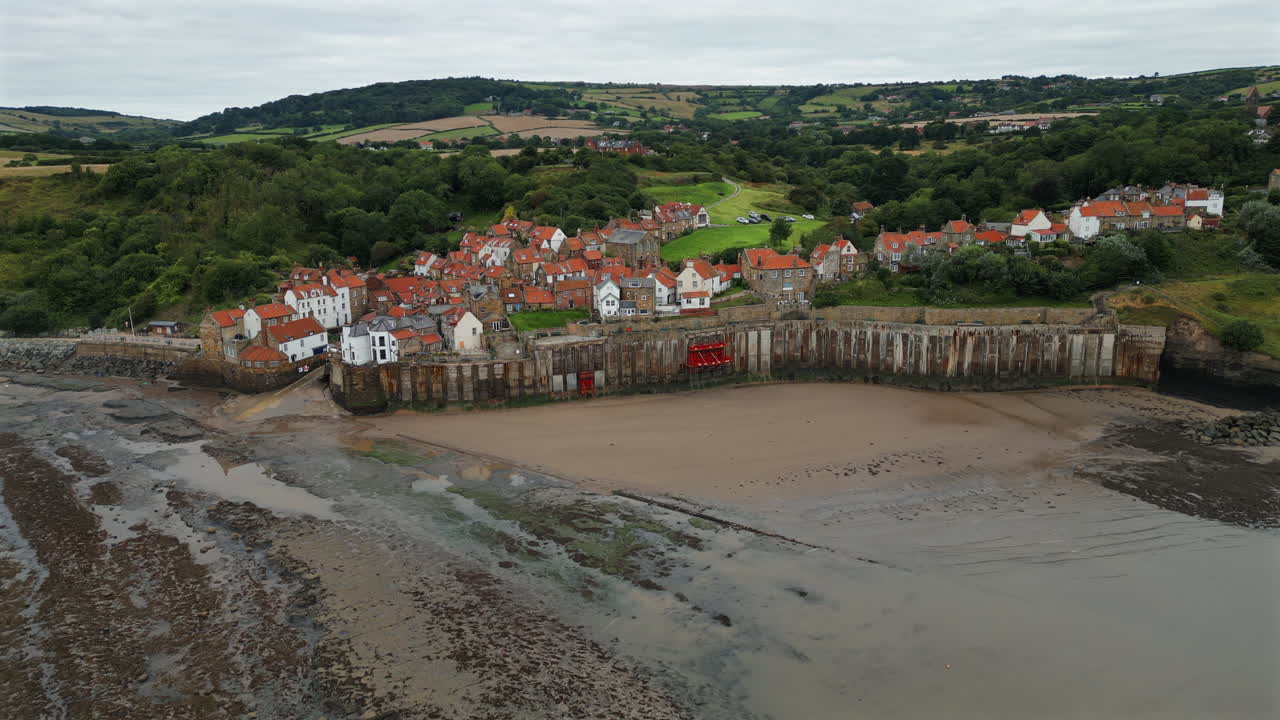 Establishing Aerial Drone Shot of Robin Hood's Bay at Low Tide on Overcast Morning