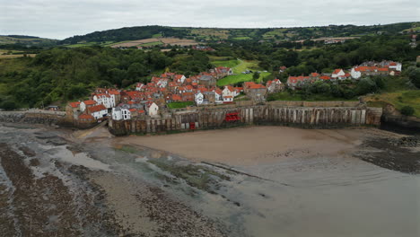 Establishing-Aerial-Drone-Shot-of-Robin-Hood's-Bay-at-Low-Tide-on-Overcast-Morning