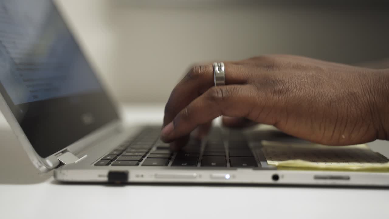 The manager is in his office typing preparing for his next meeting.